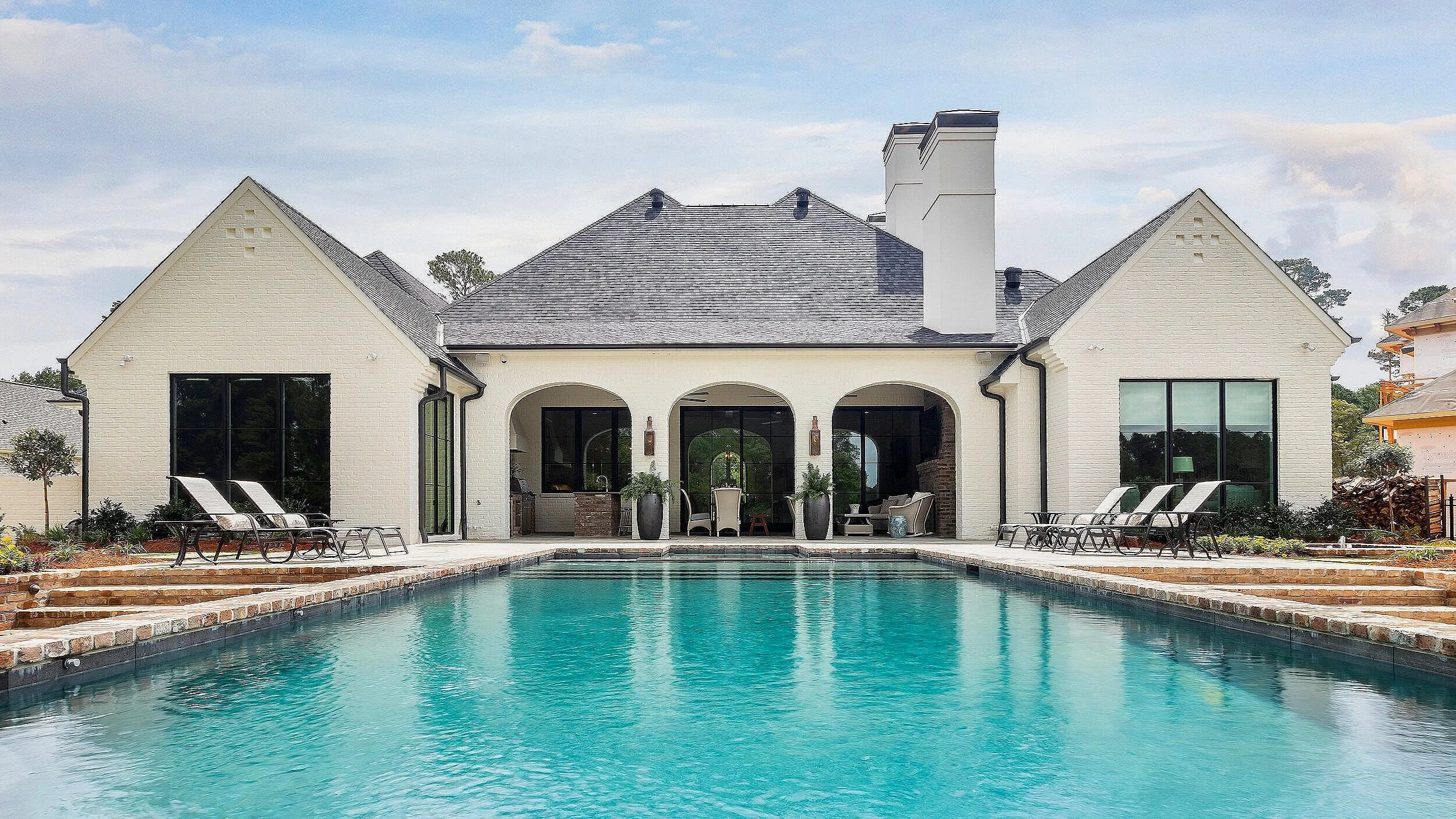 Outdoor entertaining area with lounging area, kitchen and swimming pool