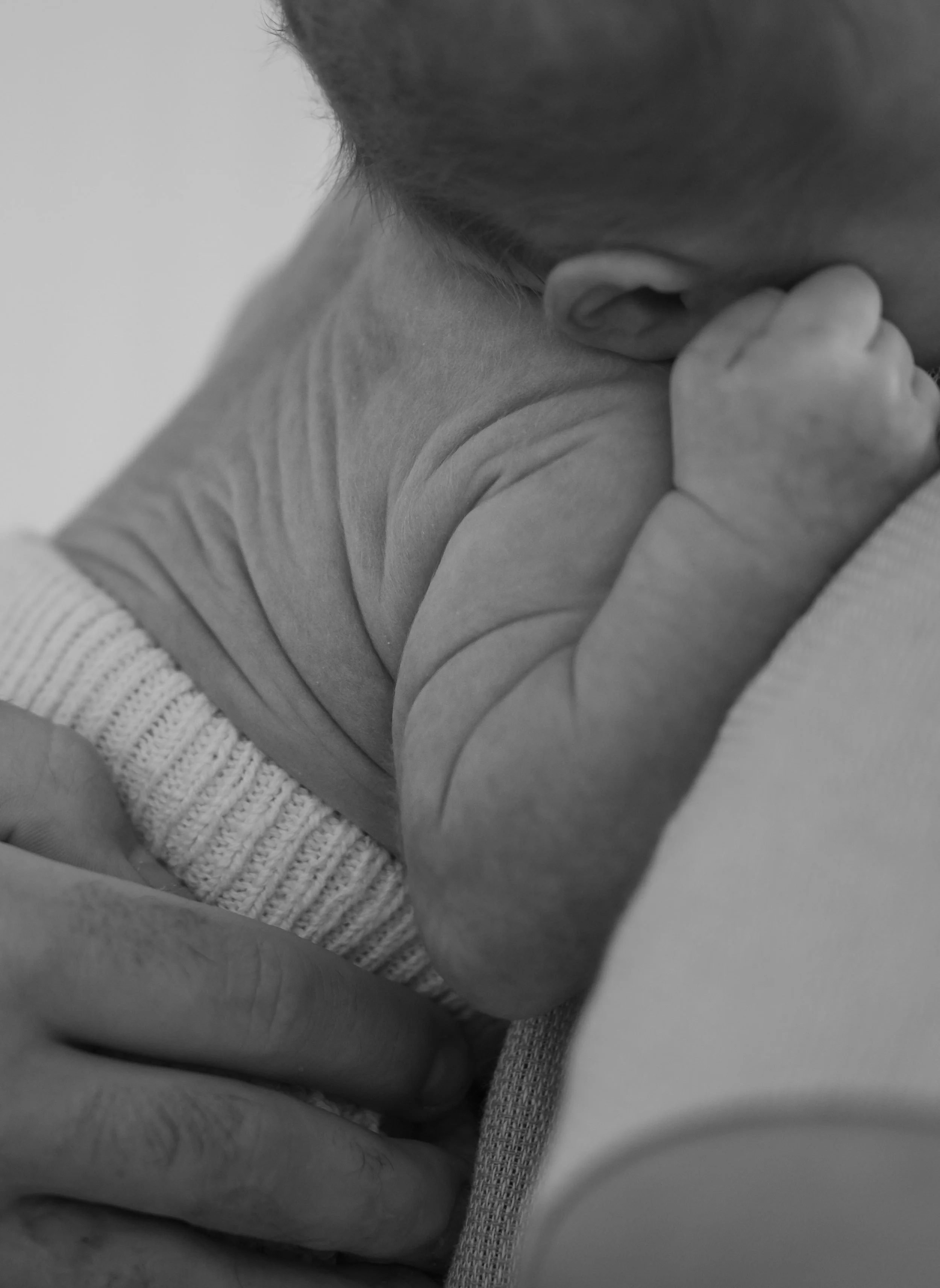 A close-up detail shot of a newborn babies rolls.