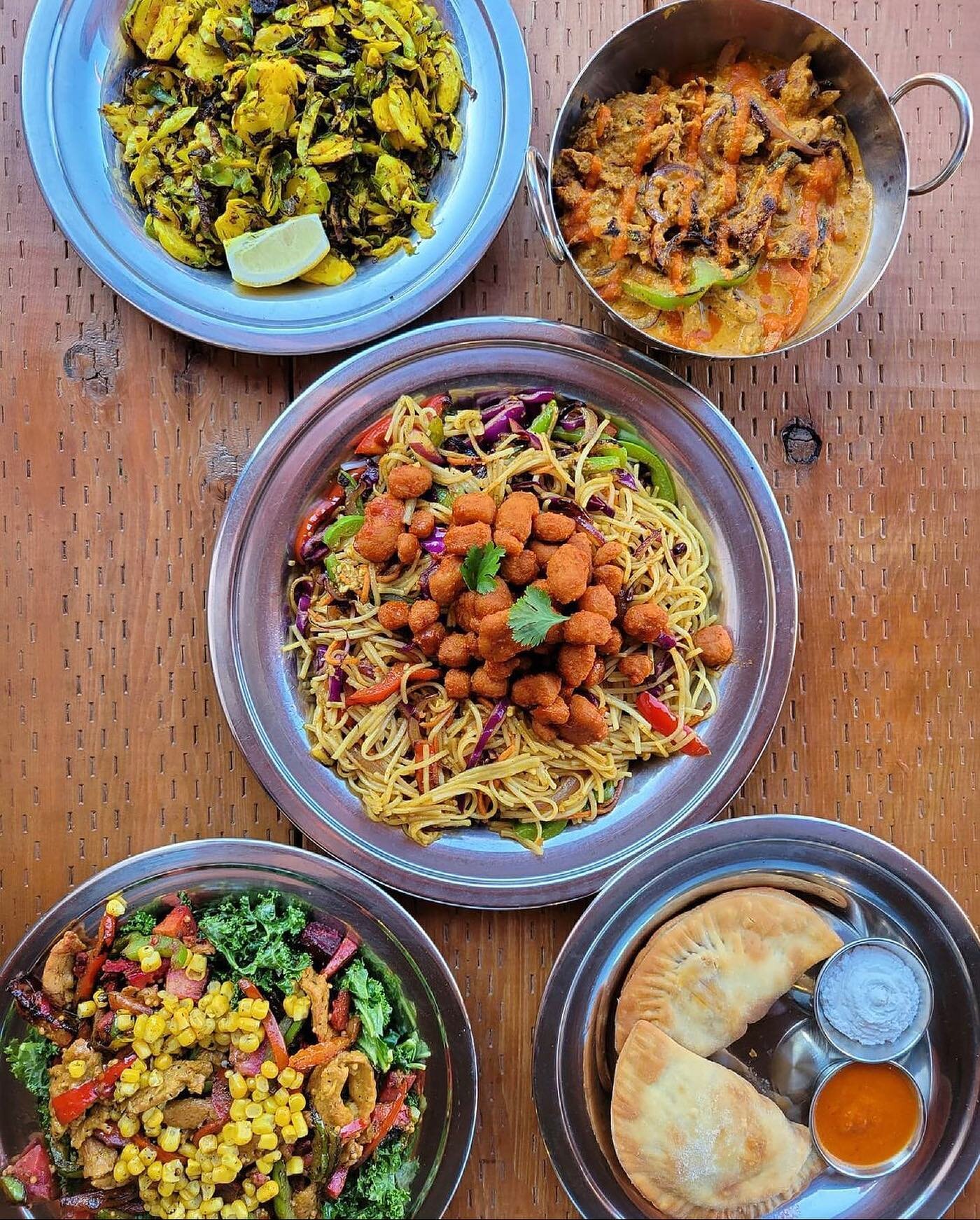 What a spread!! 😍😋 @portlandveg stopped by our Mississippi location and enjoyed some of his faves. Clockwise from top left: turmeric roasted Brussels sprouts, soy curl tikka masala bowl, Indo-Chinese noodle plate, paneer samosas (made in-house with