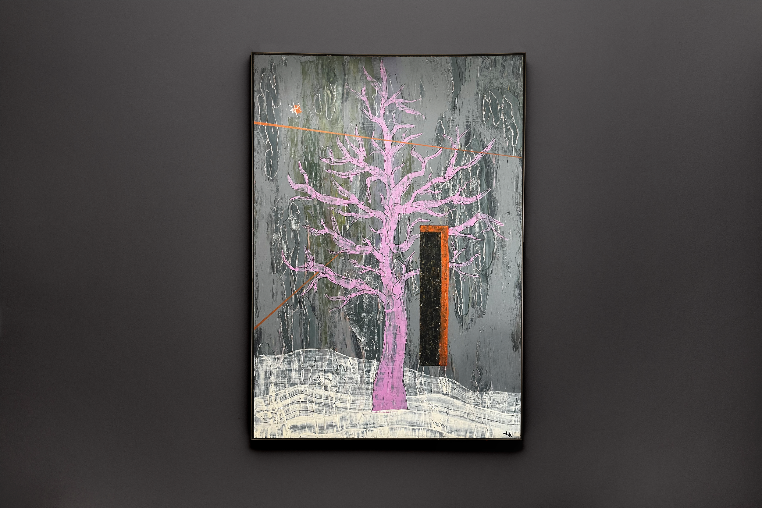A painting of a leafless tree with pink branches against a textured gray background, with orange streaks and a small orange star shape in the upper left, displayed on a dark gray wall.