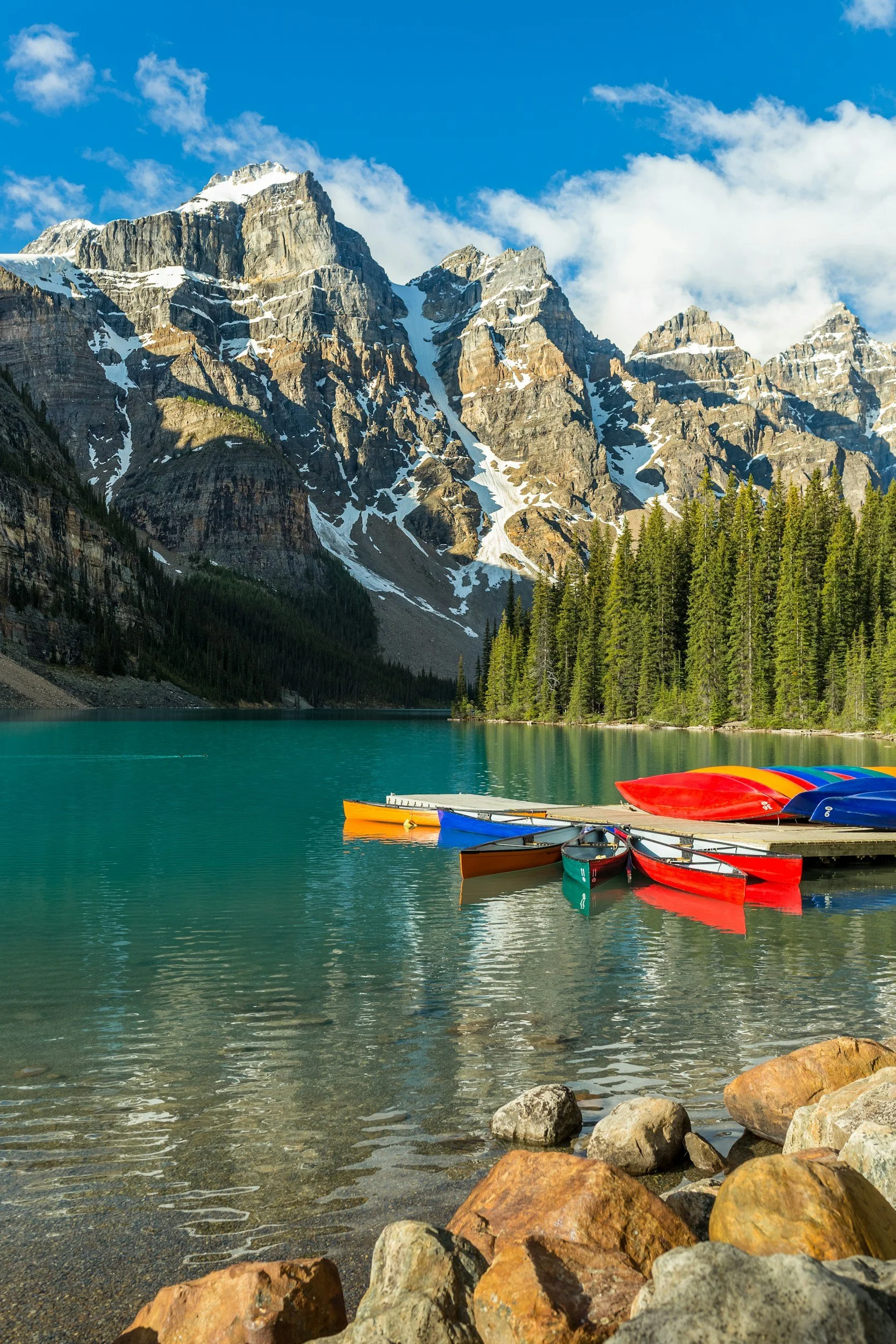 Canoes in a lake with mountains overlooking