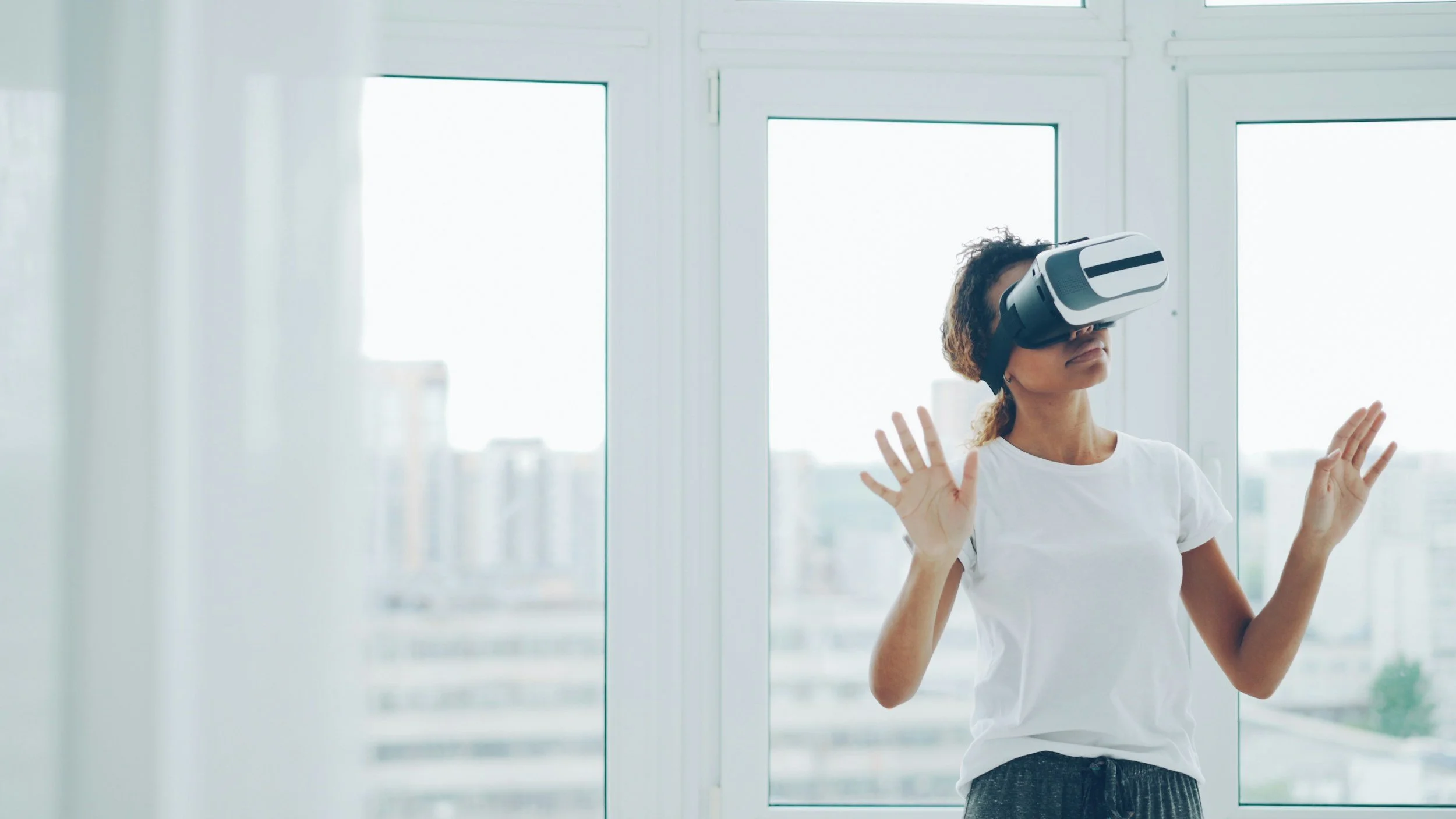 Woman wearing virtual reality glasses for VRET therapy.