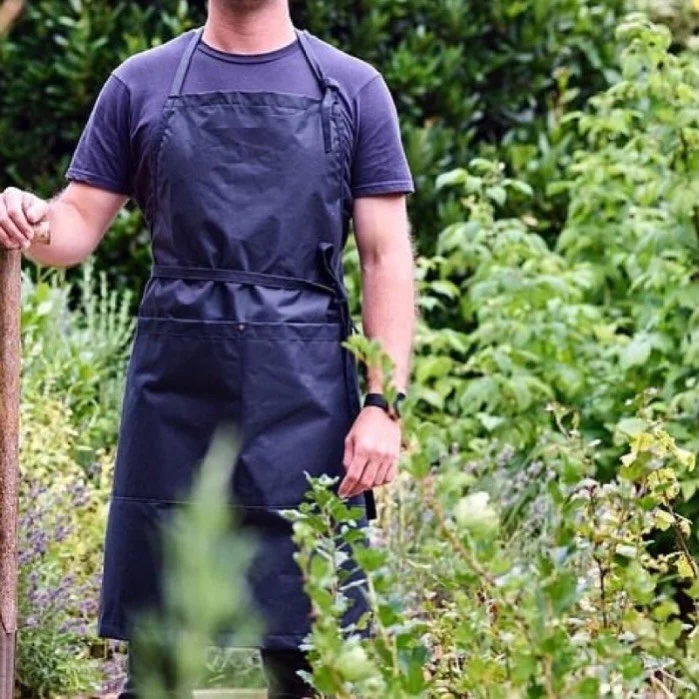 British, waxed cotton aprons handcrafted in our Somerset studio.
This image shows our Original full bib in Classic wax which basically means it&rsquo;s wipe clean only! 
No washing needed, just wipe down at the end of the day with a clean, damp cloth