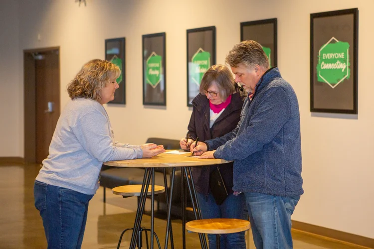 A Guest Services volunteer helping guests at the welcome desk