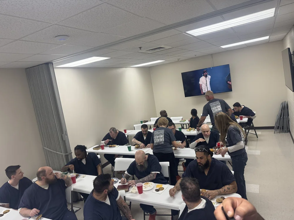 Freedom Church volunteers serving a meal to men at a correctional facility