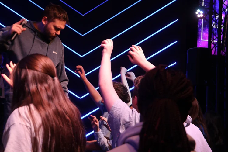 People worshiping with hands raised