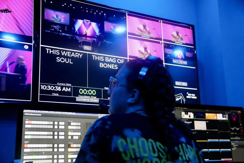 A production volunteer running lyrics and cues from the Freedom Church tech booth