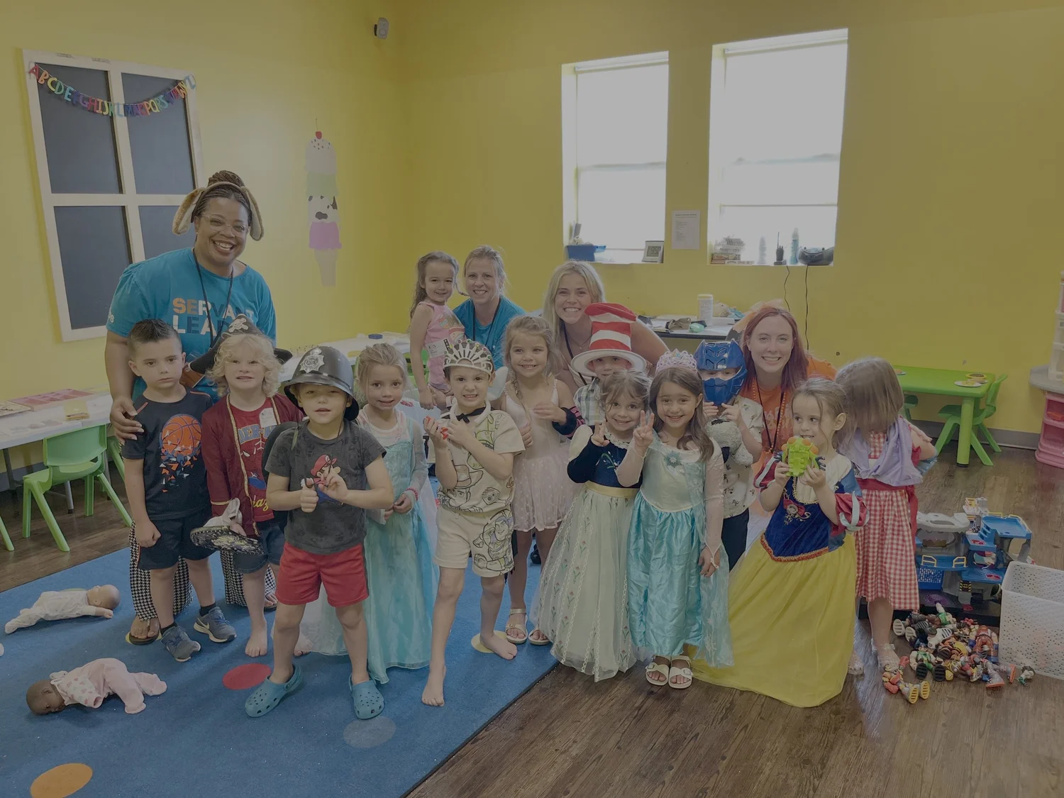 Smiling kids with their Freedom Kids leaders in a colorful classroom