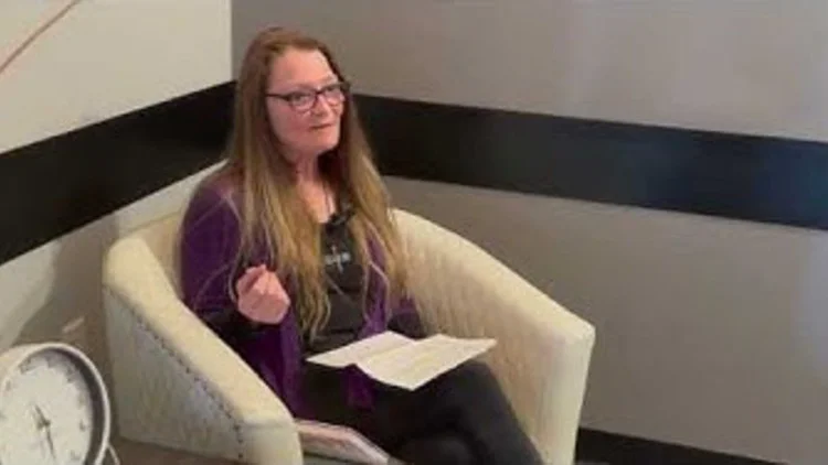 A woman sharing her testimony on camera