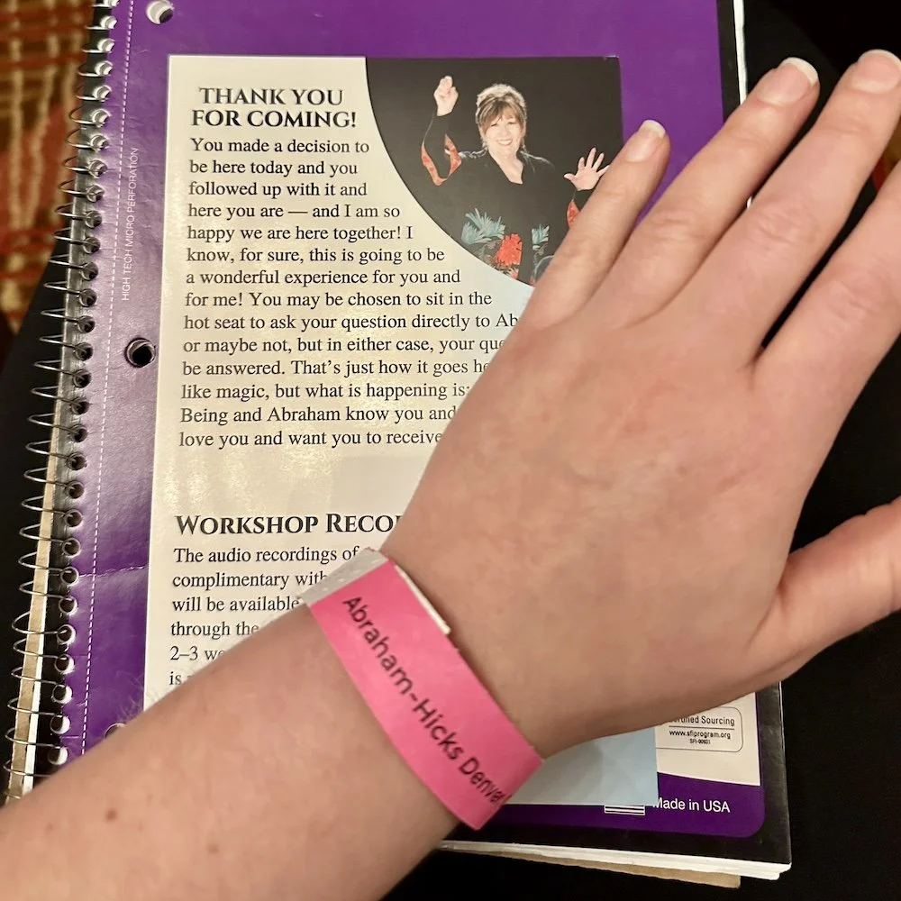 My notebook and wristband at a live Abraham Hicks workshop in Denver
