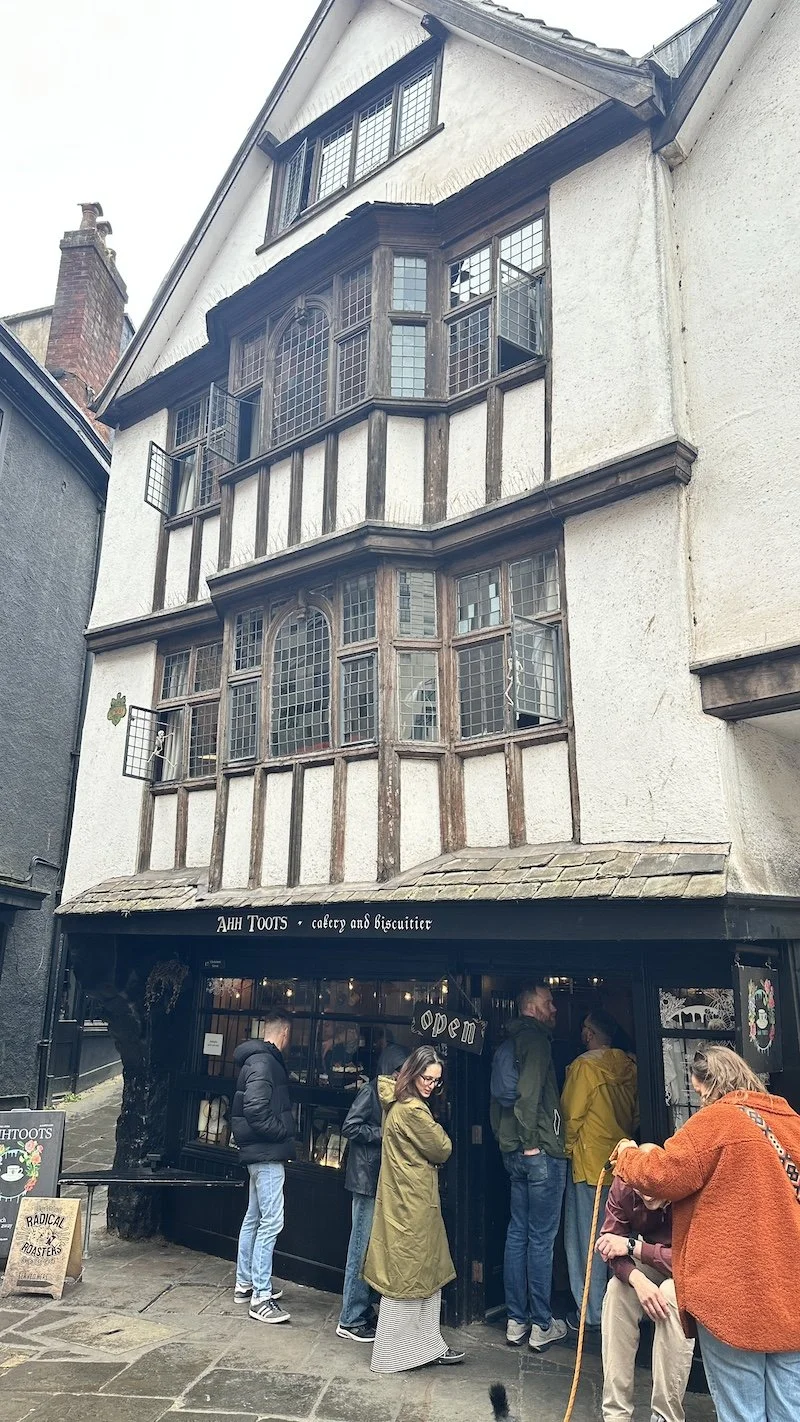 Old building in Bristol, UK, with a cakery and biscuitier