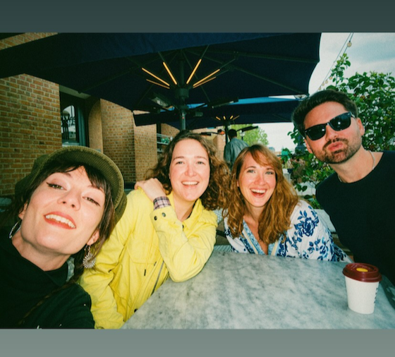 Suzie DeVoe smiling with three other friends in London