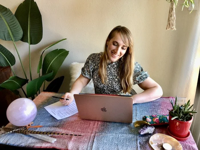 Suzie DeVoe connecting with a healing client online on her laptop