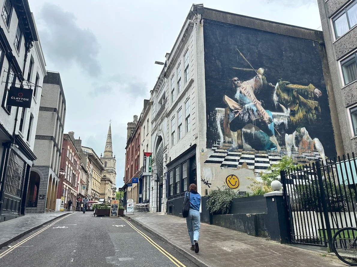 Bristol, UK, street view with graffiti and woman walking