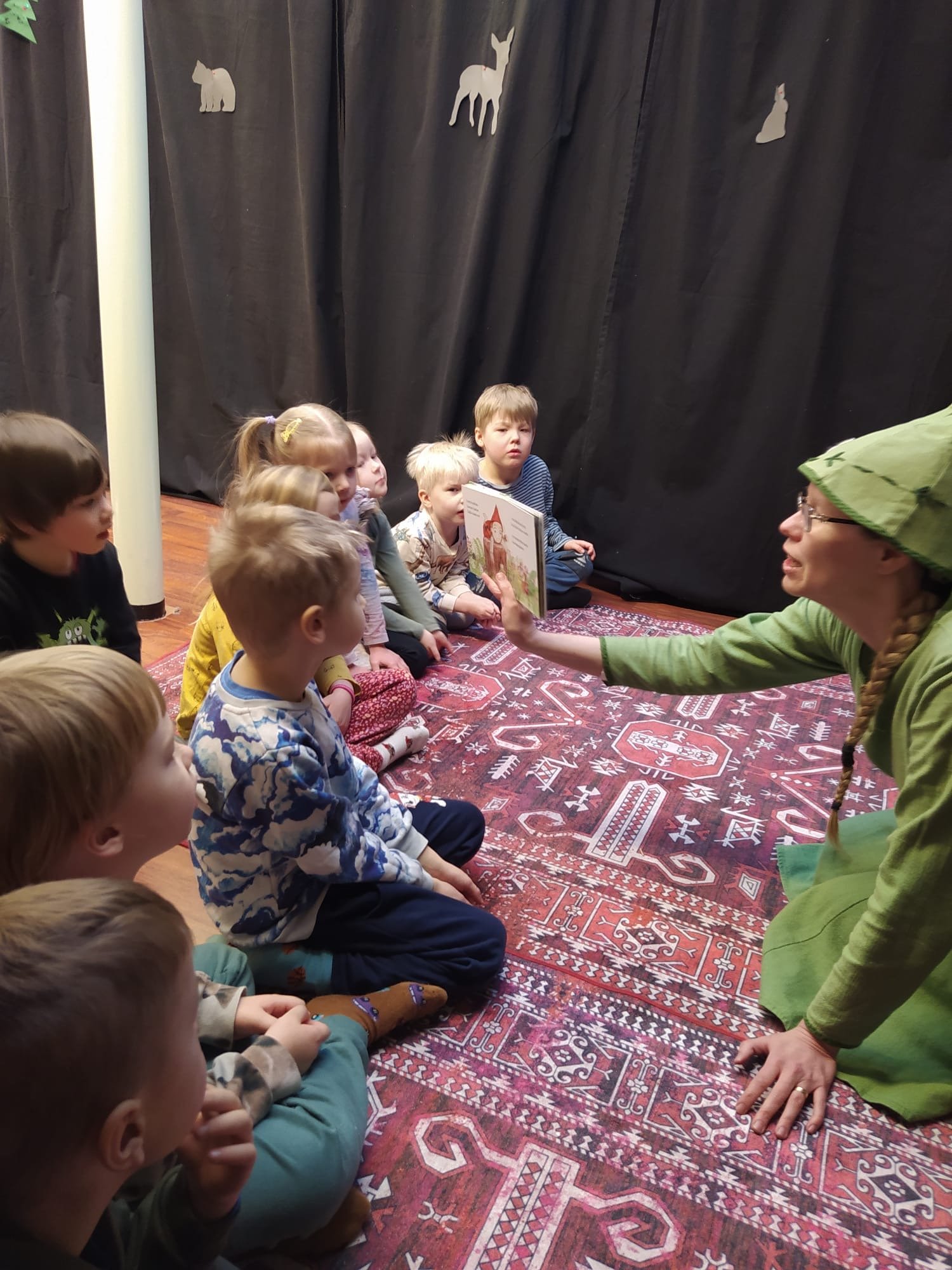 Lapset katsomassa kirjan kuvaa