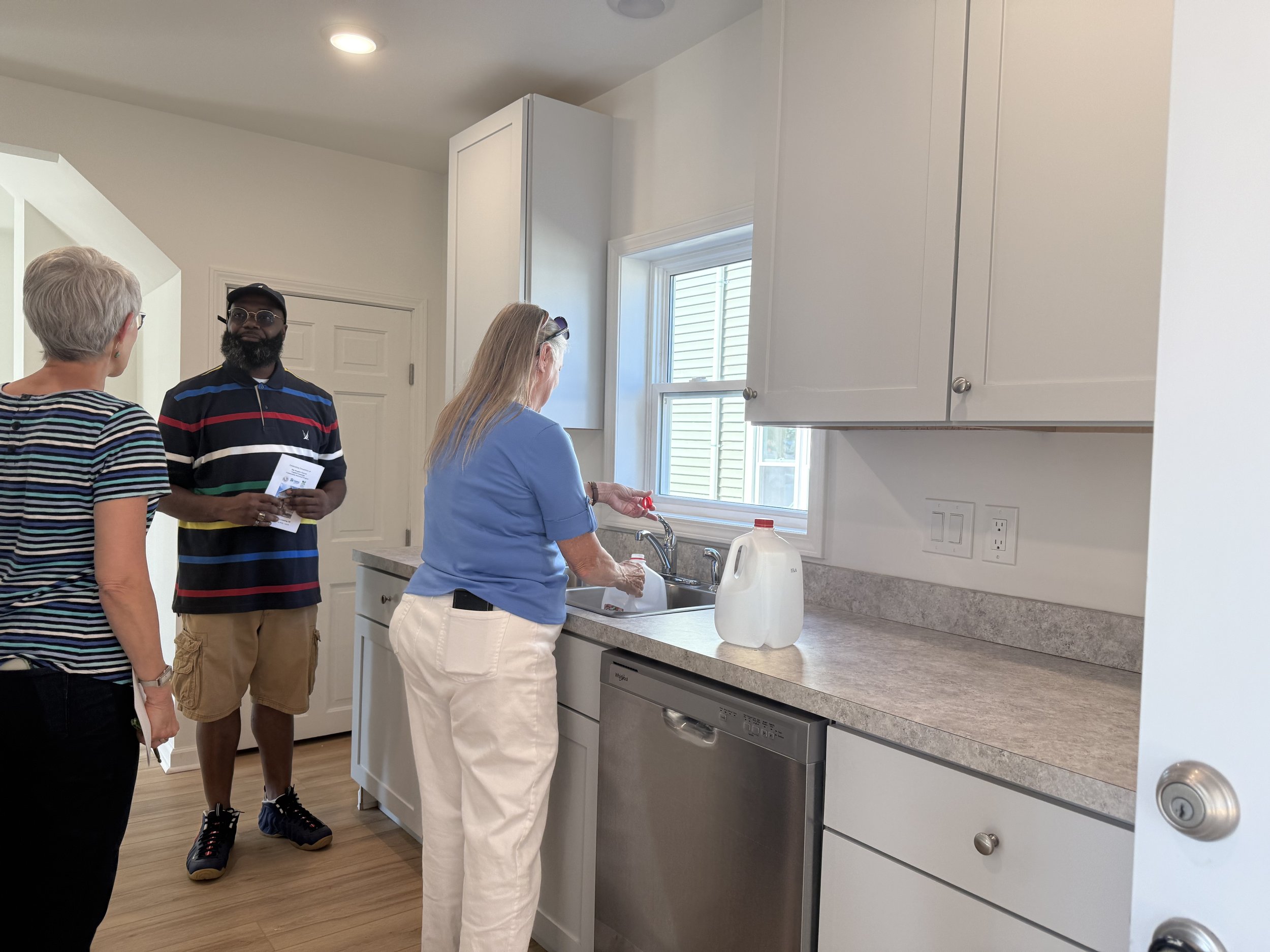 Jana_James_Kim in lower level kitchen.jpeg