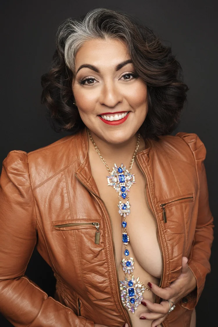 Smiling boudoir portrait in a leather jacket