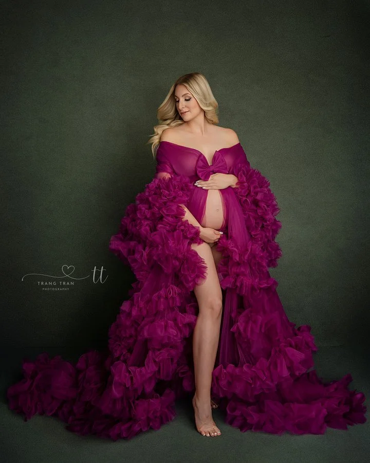 Denver maternity photographer – studio portrait in bold magenta ruffled robe, elegant fine art look.
