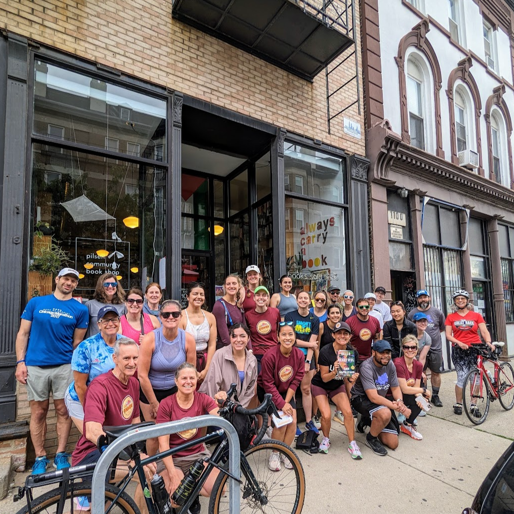 Runners in front of Pilsen Community Books in Pilsen