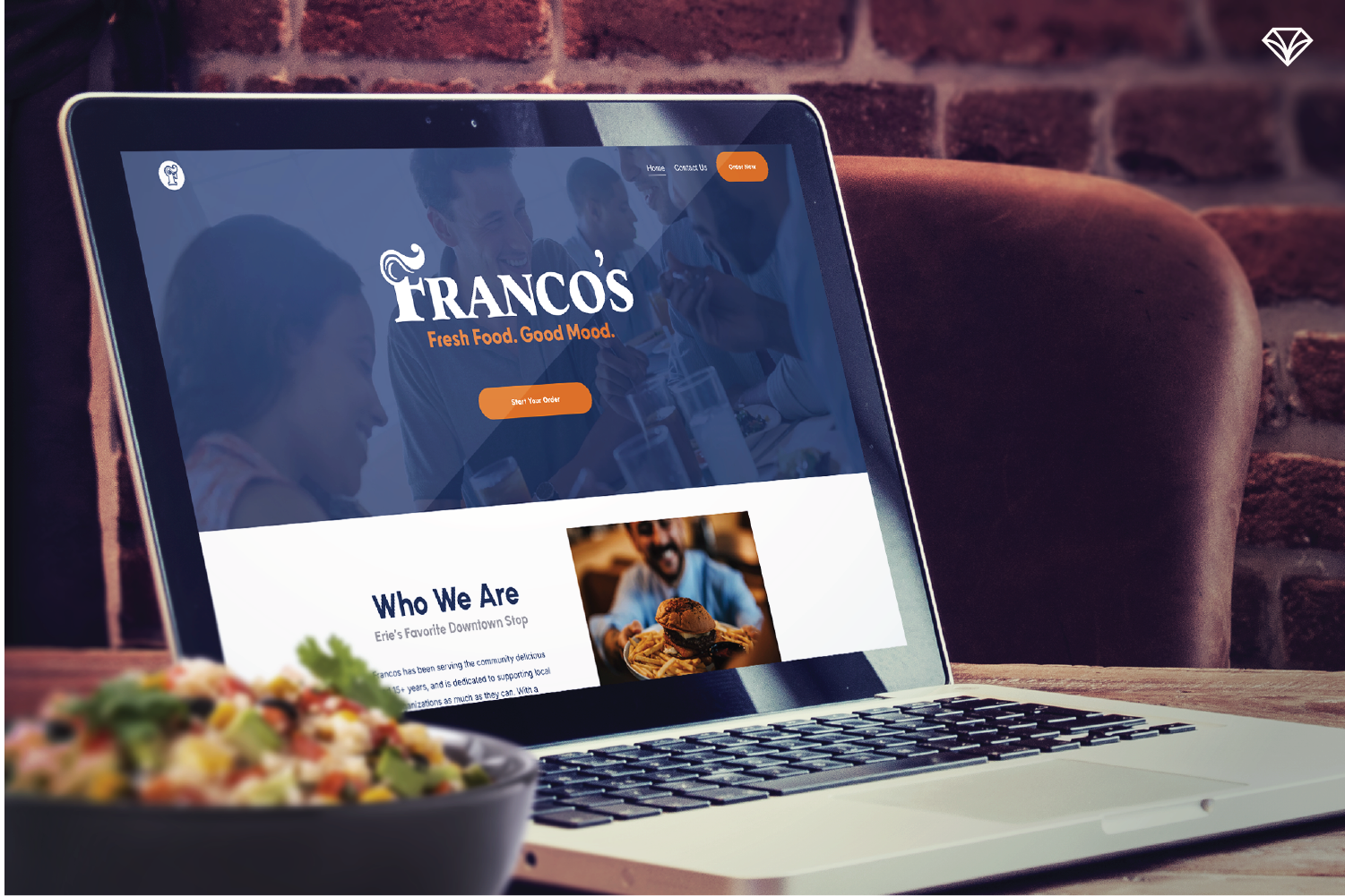 A laptop that is open to the new Franco's website.