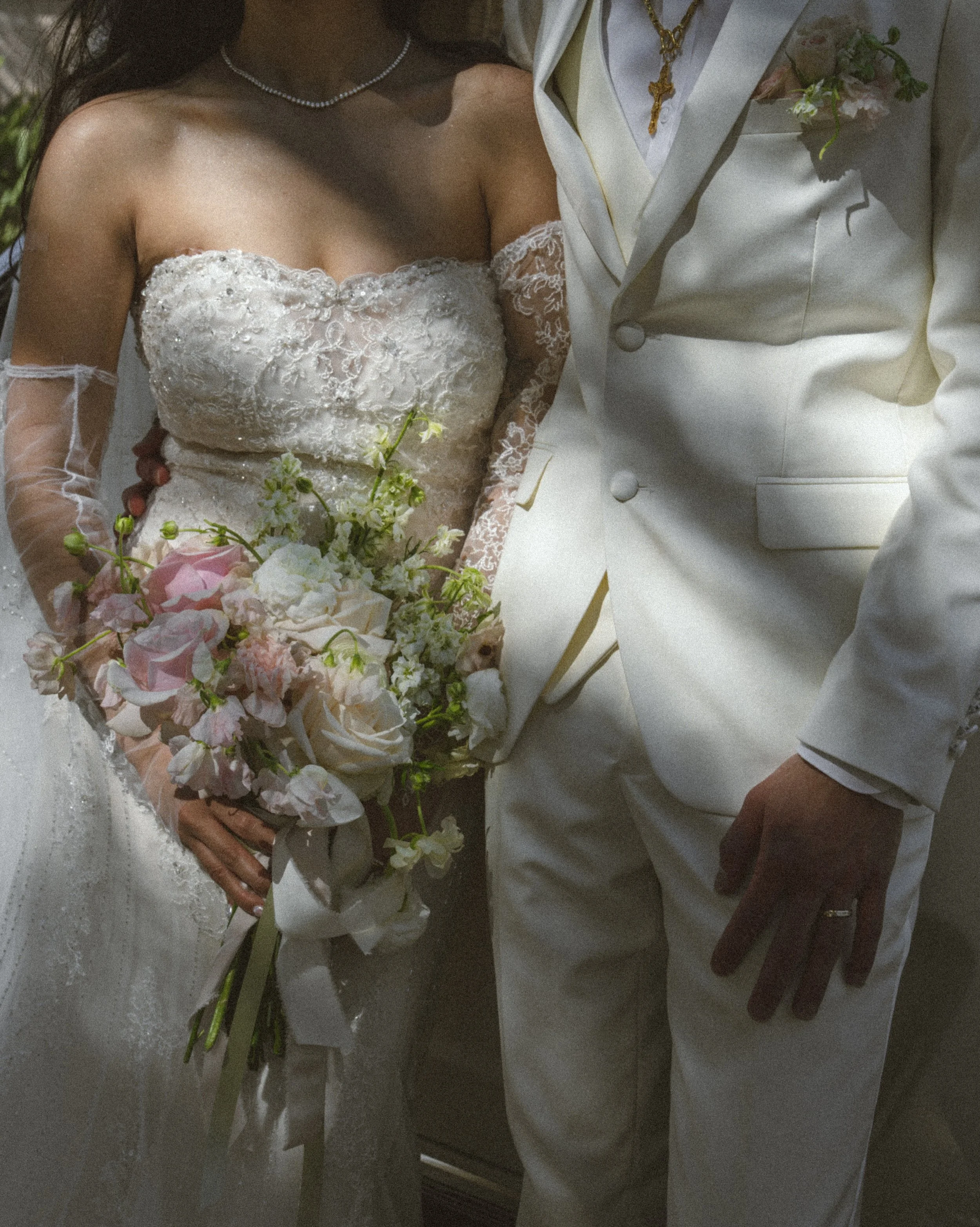 Blush butterfly ranunculus brought delicate movement, while white ranunculus added soft, layered blooms. Sweet peas introduced an airy touch, white larkspur created height, and mondial and vendela roses brought timeless elegance. Finished with blush 