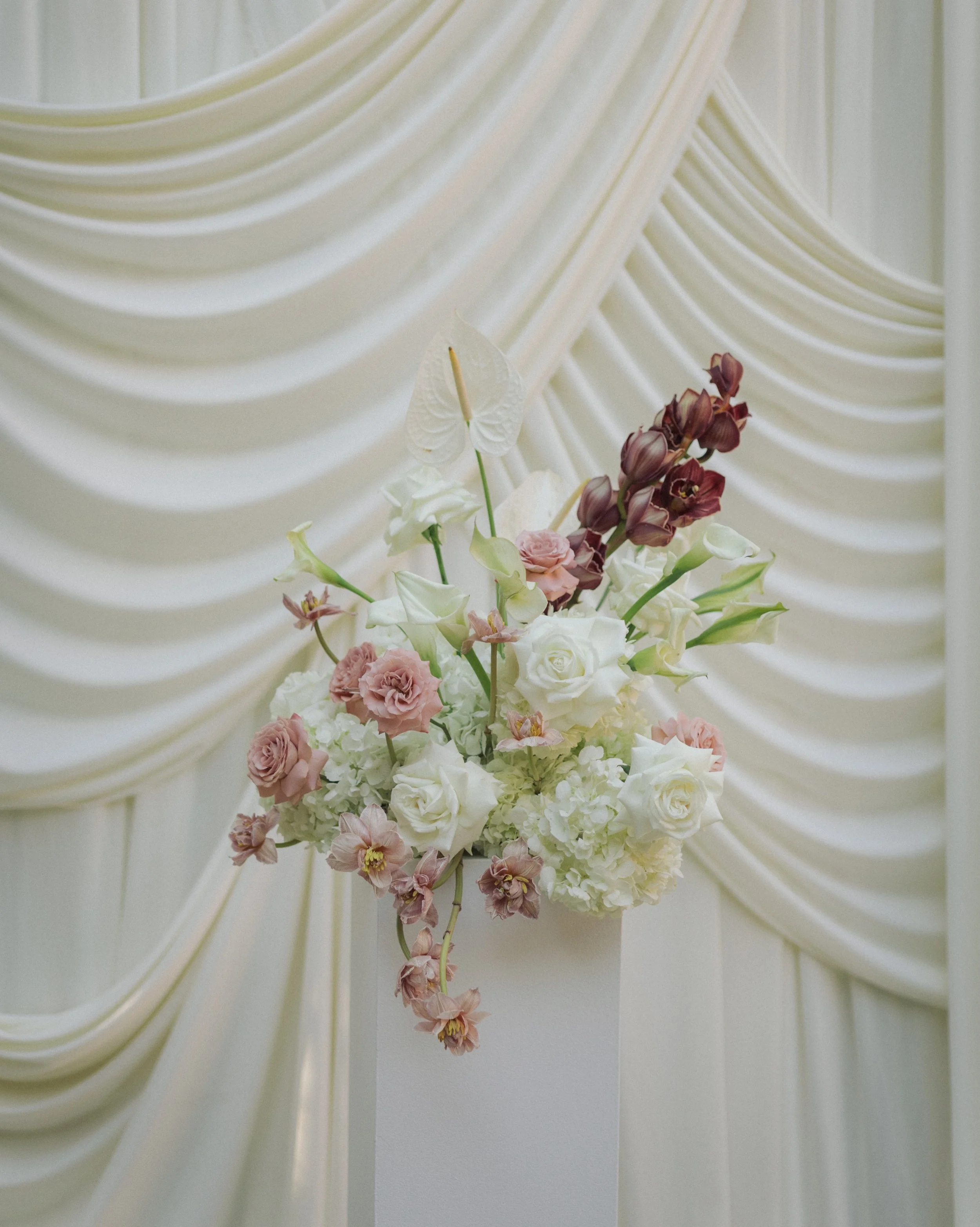 Reception of their dreams: romantic draping, moody cymbidium, intricate stems, chrome bud vases, candles everywhere, and all their loved ones 🤍

Venue: @franciscangardens
Photo: @khoa.photography
Content creator: Amanda for @socialdreamhaus
Florals: