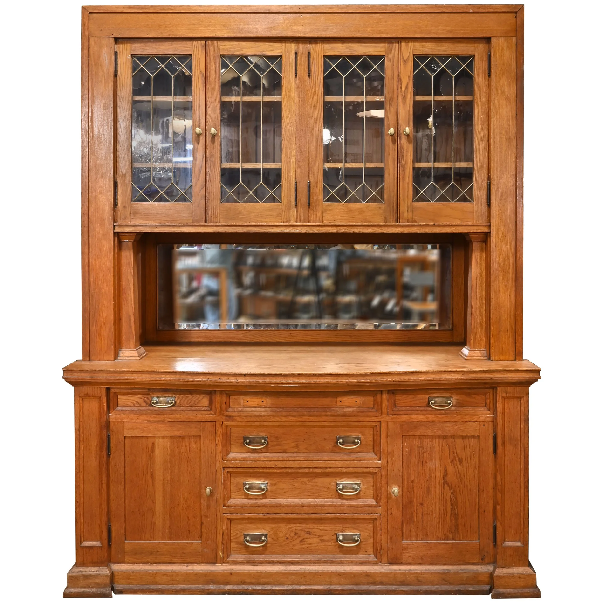 golden oak buffet with curved countertop and brass hardware
