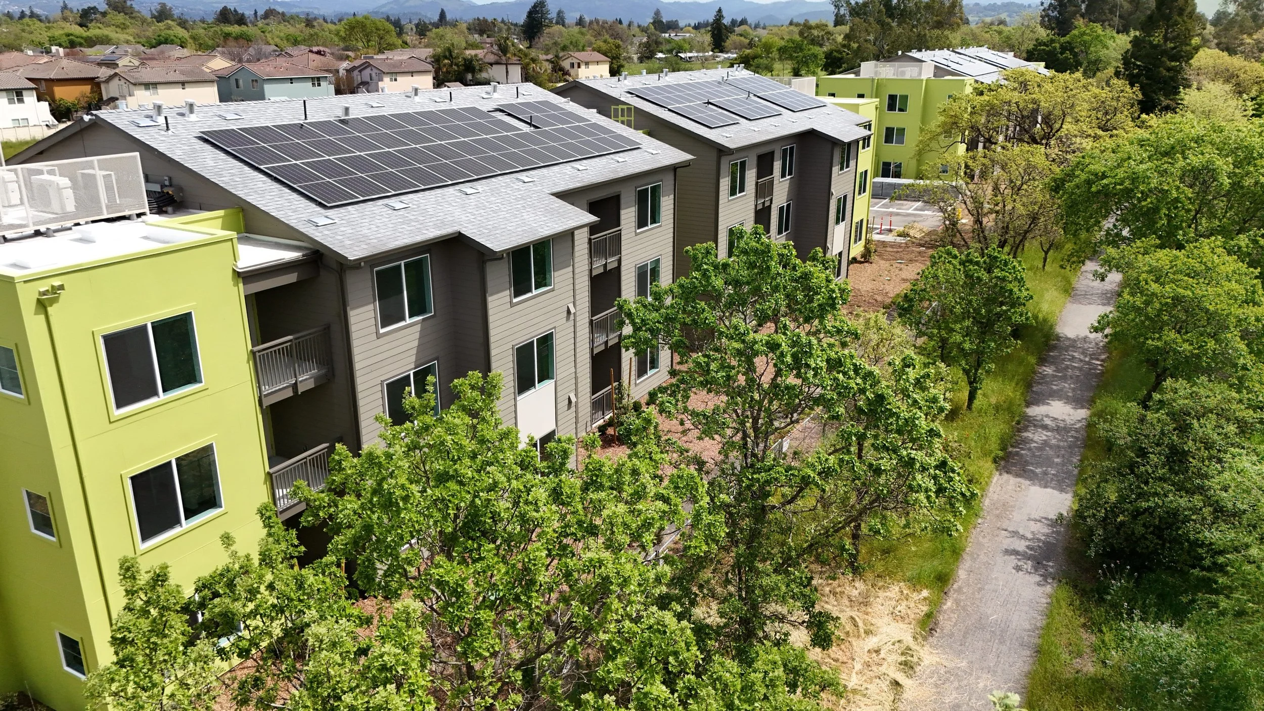 apartments along a creek path with trees