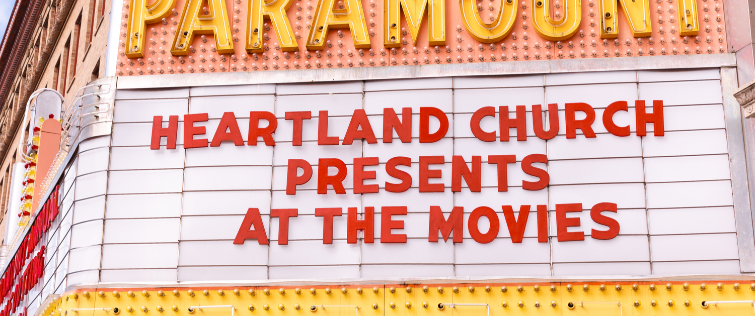 Theater marquee reading Heartland Church presents At the Movies