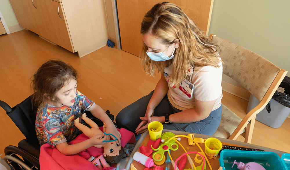  Aaliyah is a frequent patient at the hospital who travels to Madison for care. Play and crafts keep her busy when she’s at the hospital alone. Aaliyah explains to Child Life Specialist Alex Gretkowksi that her doll needed to go to the hospital for a