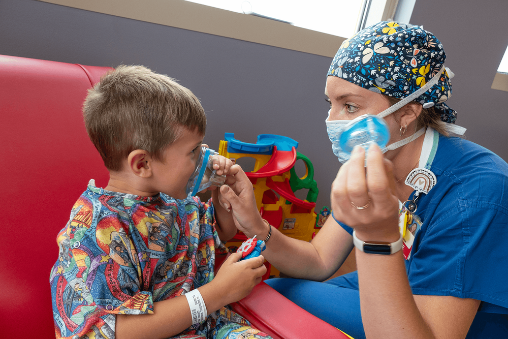  Child Life Specialist Brittni Jegerlehner uses medical play to help Teddy understand what will happen when he has his tonsils and adenoids removed. “Child Life helped demystify the process and make it less scary. We’re sitting here as parents watchi