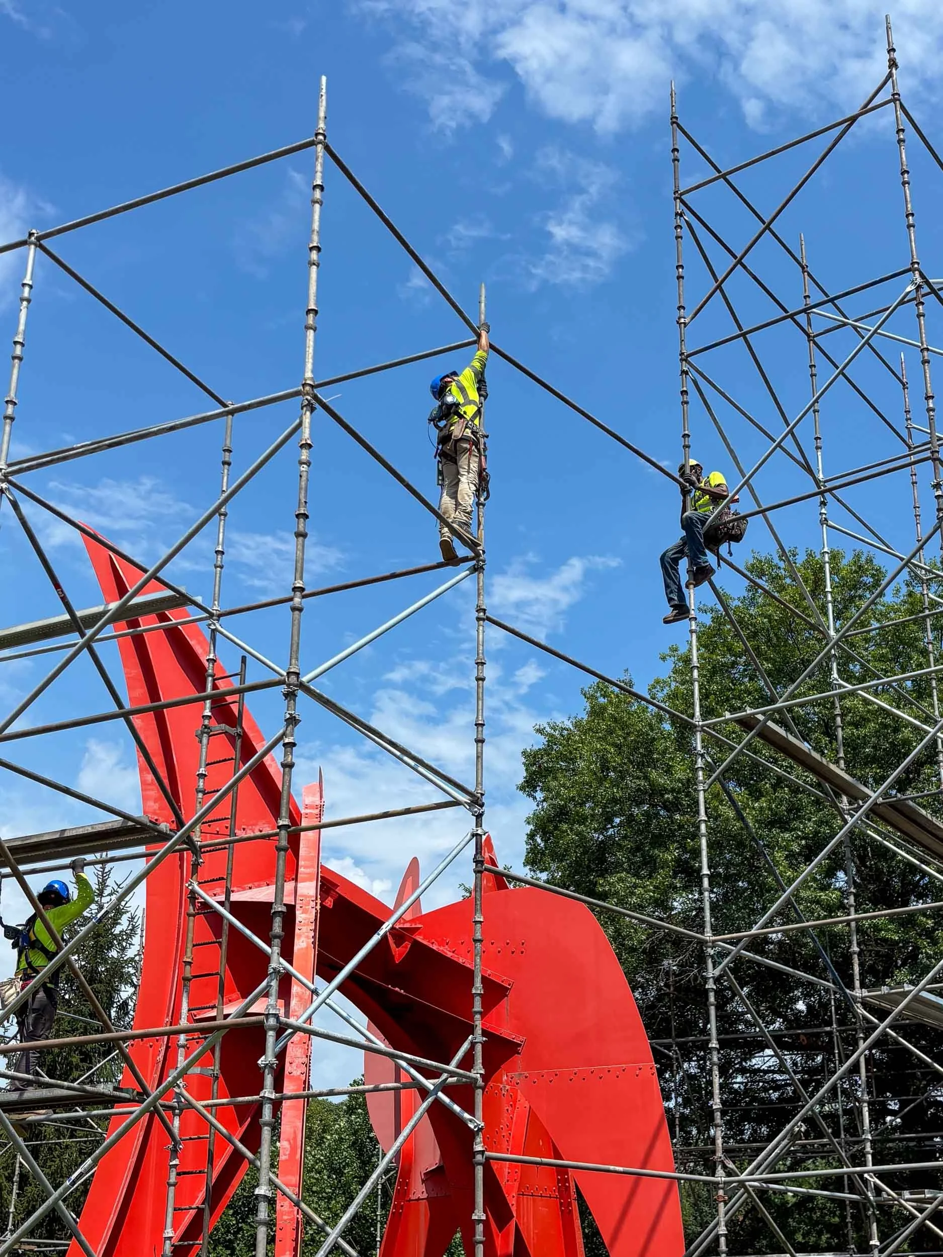 Erecting scaffolding for blast media and paint containment structure