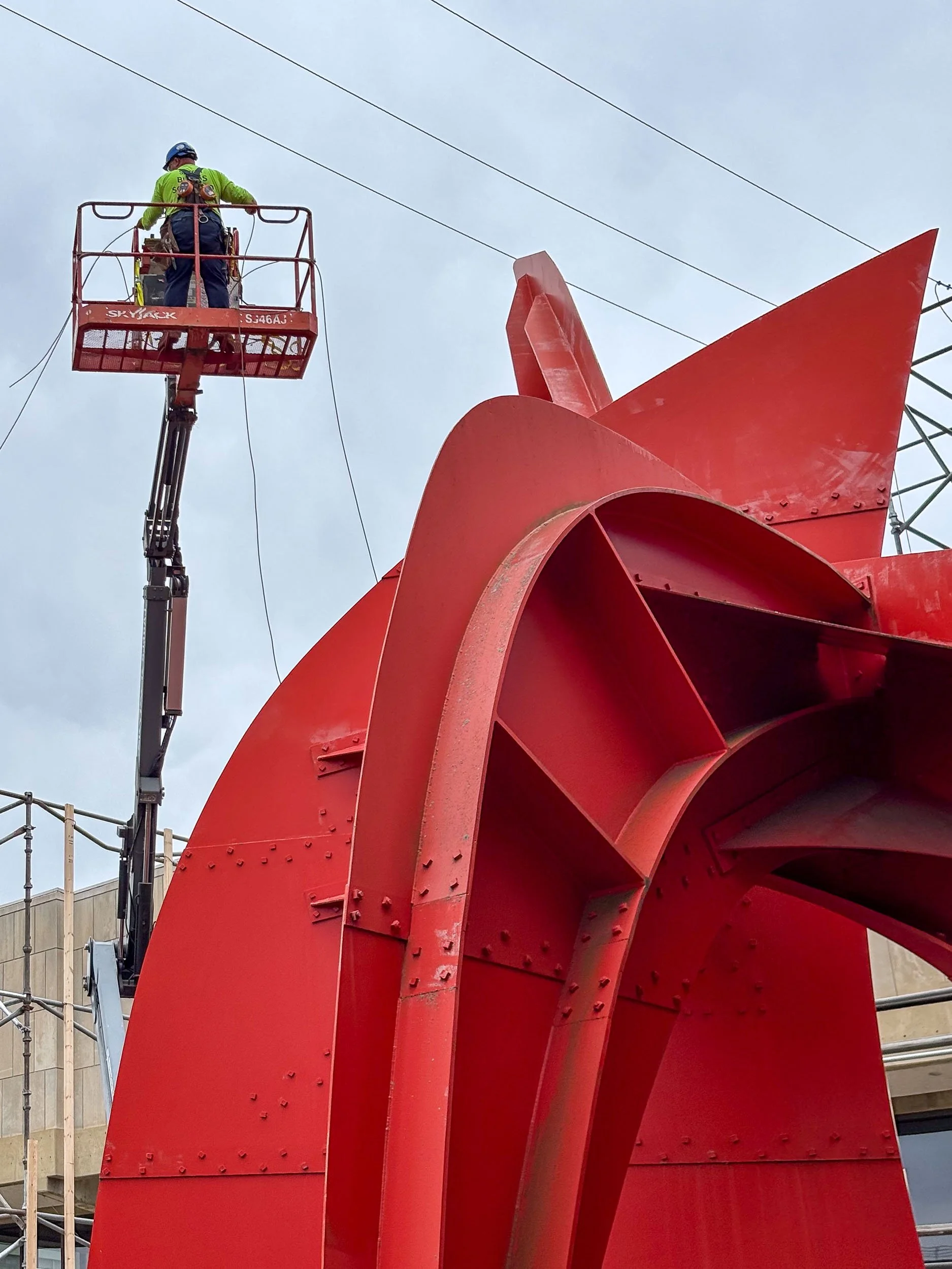 Erecting scaffolding for blast media and paint containment structure