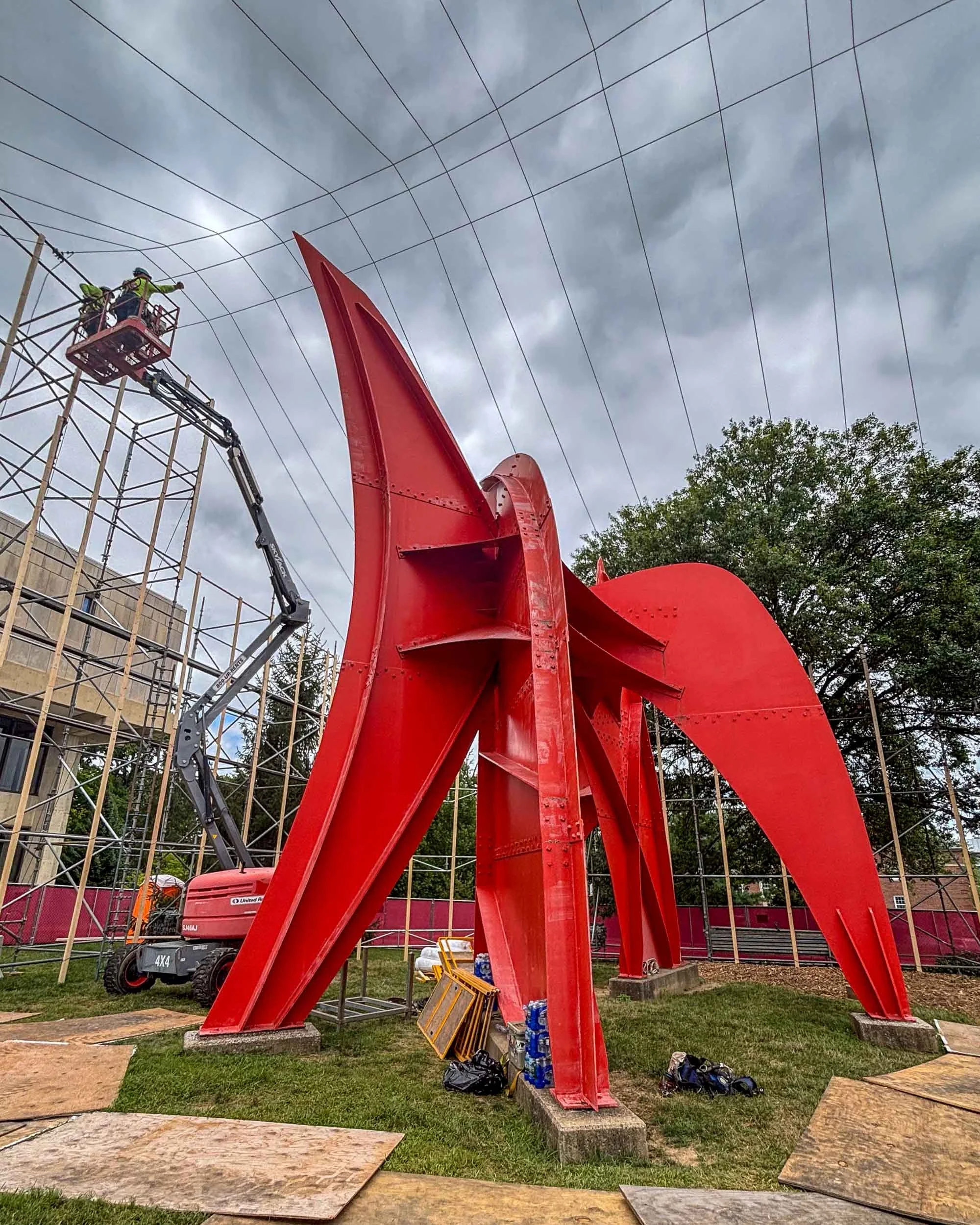 Erecting scaffolding for blast media and paint containment structure