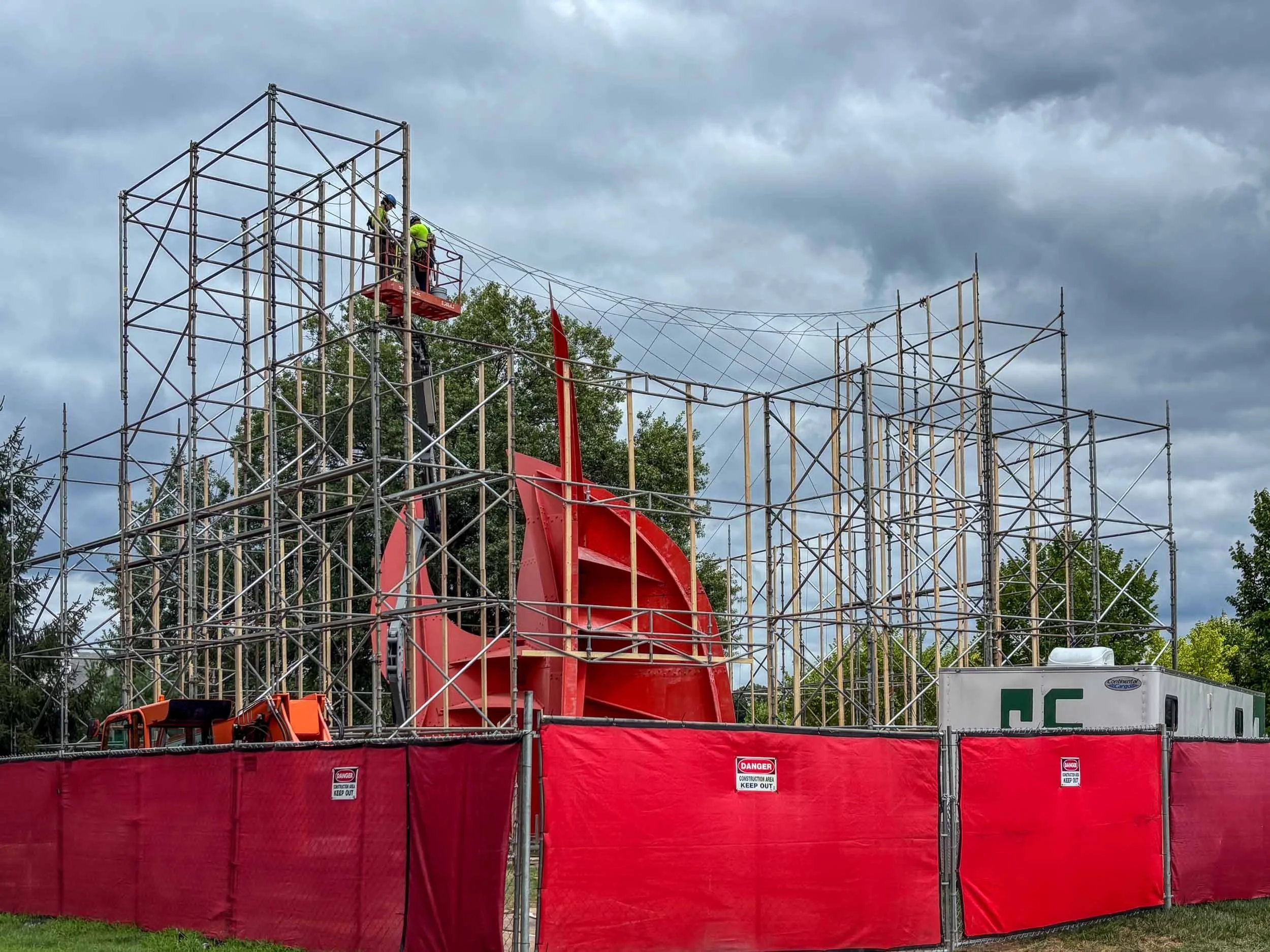 Erecting scaffolding for blast media and paint containment structure
