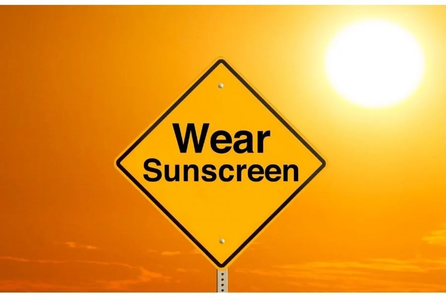 Yellow traffic sign that says, Wear Sunscreen.