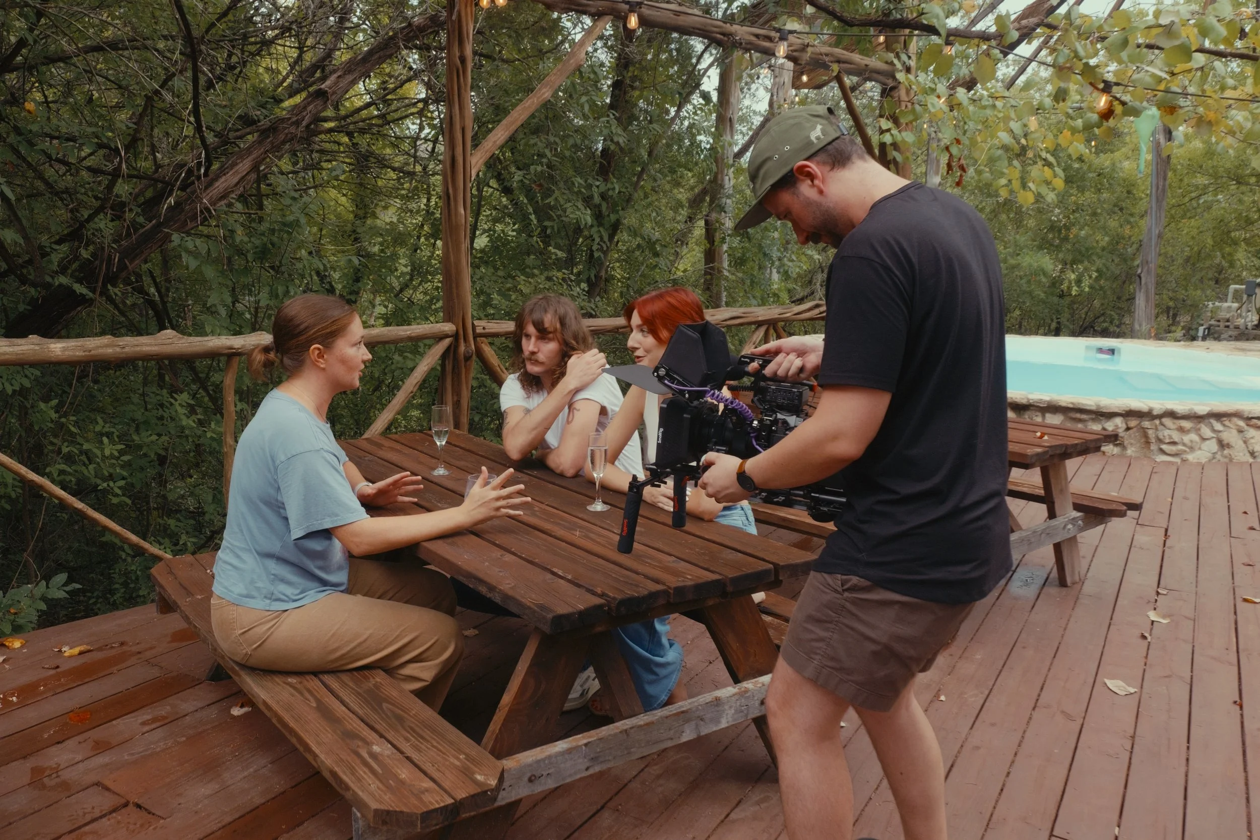 Video production behind the scenes, camera operator filming at luxury hotel