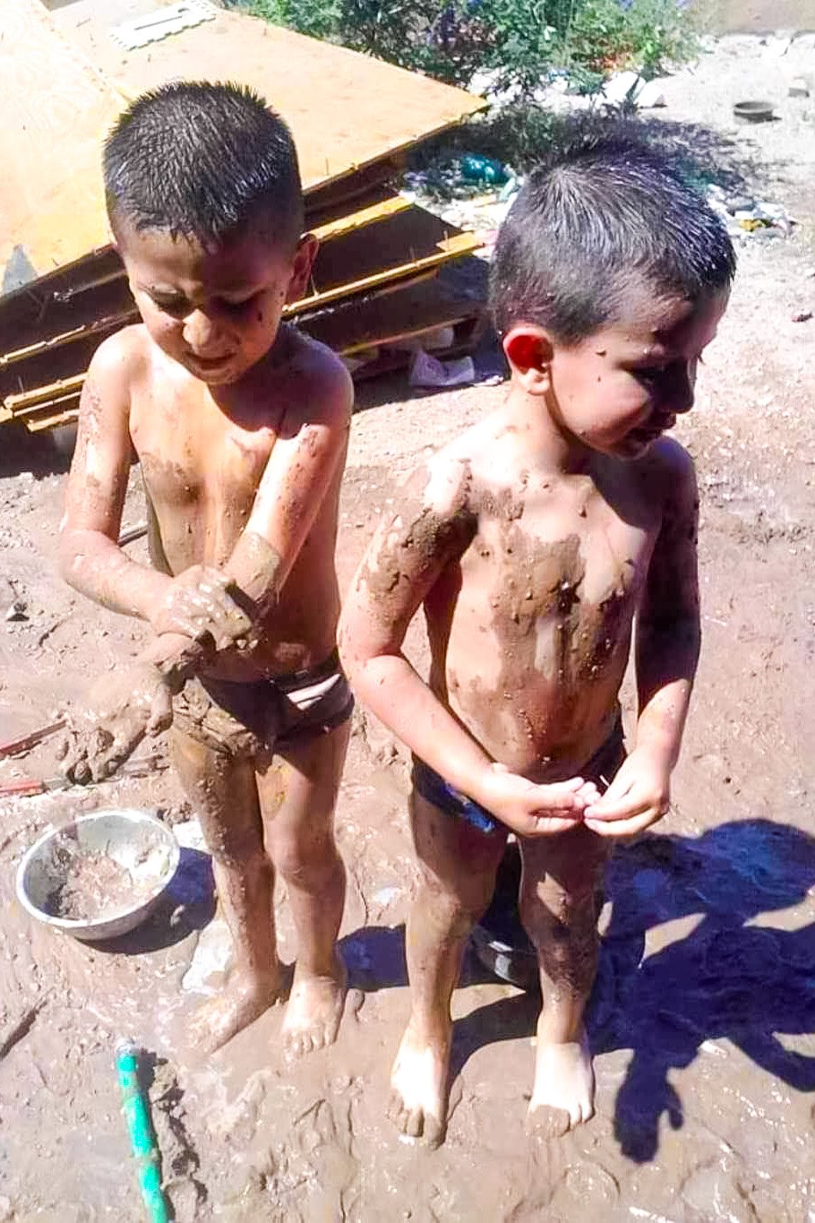 Felipe and his brother playing in mud.jpg