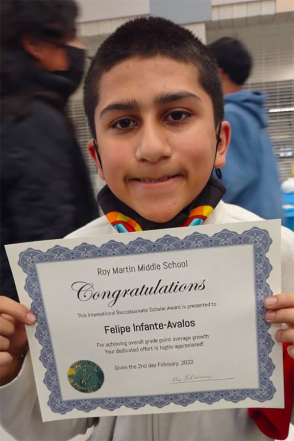 Felipe with a certificate from school.jpg