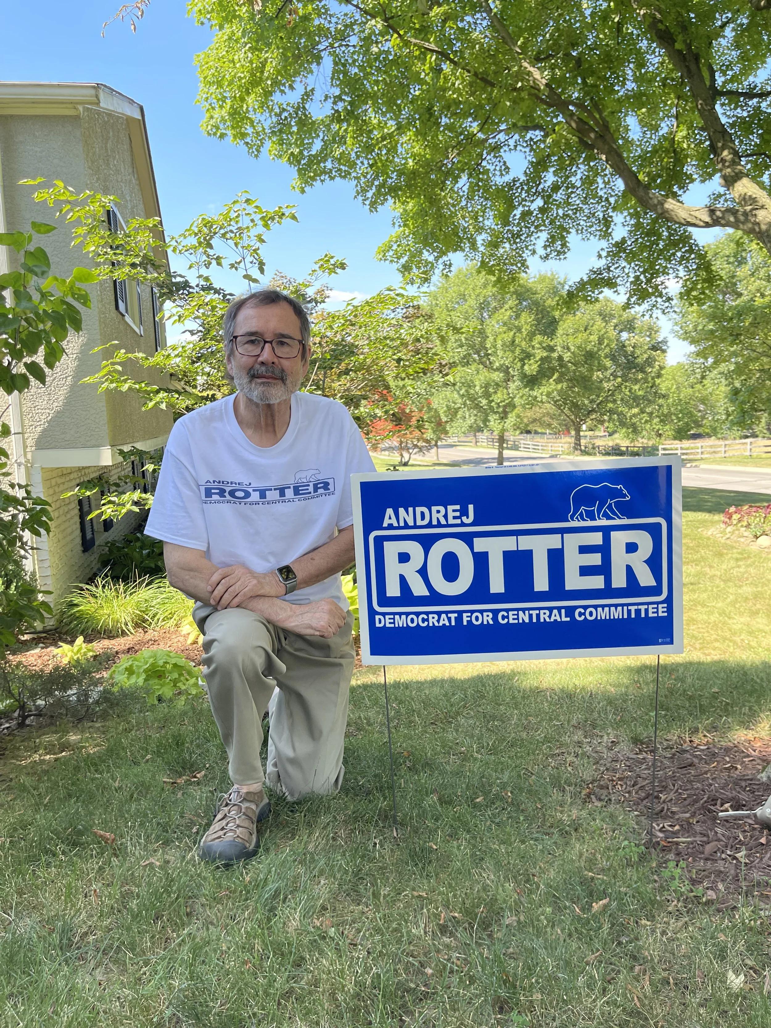 Andrej Rotter standing by his campaign sign for UA City Council.