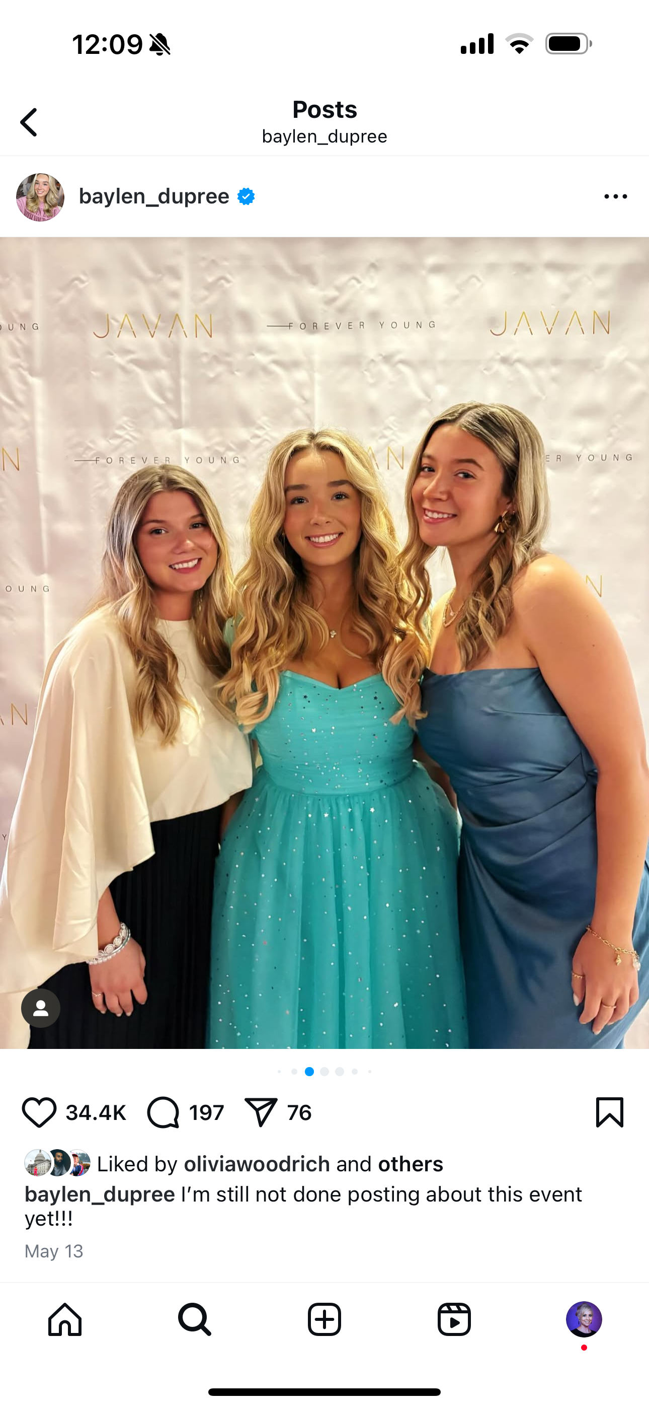 Three young women in formal dresses standing together at an event, smiling for the camera, with a backdrop that has the words 'JAVAN' and 'FOREVER YOUNG' on it.