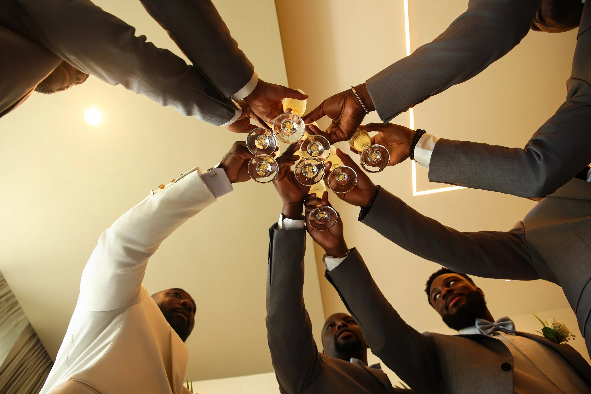 A group of people in formal attire toasting with glasses of champagne at a celebration or event.