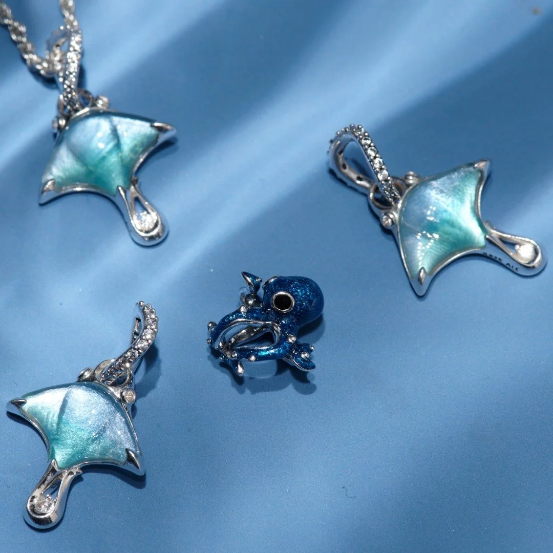 Summer is calling at @theofficialpandora ☀️

It&rsquo;s stacking up to be your most colorful summer yet! 🌊 Dive in with colorful charms in 14k gold plating or sterling silver, featuring vibrant Murano glass and sparkling man-made stones. 💎 

Visit 