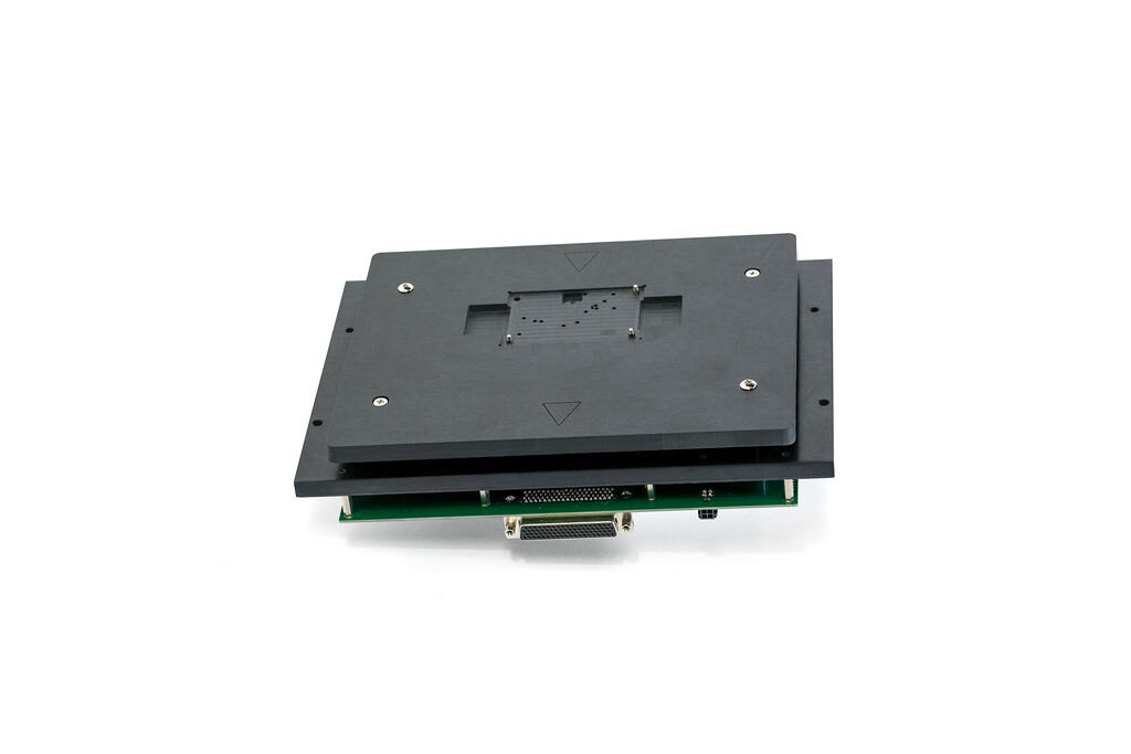 Black electronic device component with a rectangular shape and screws on a white background.
