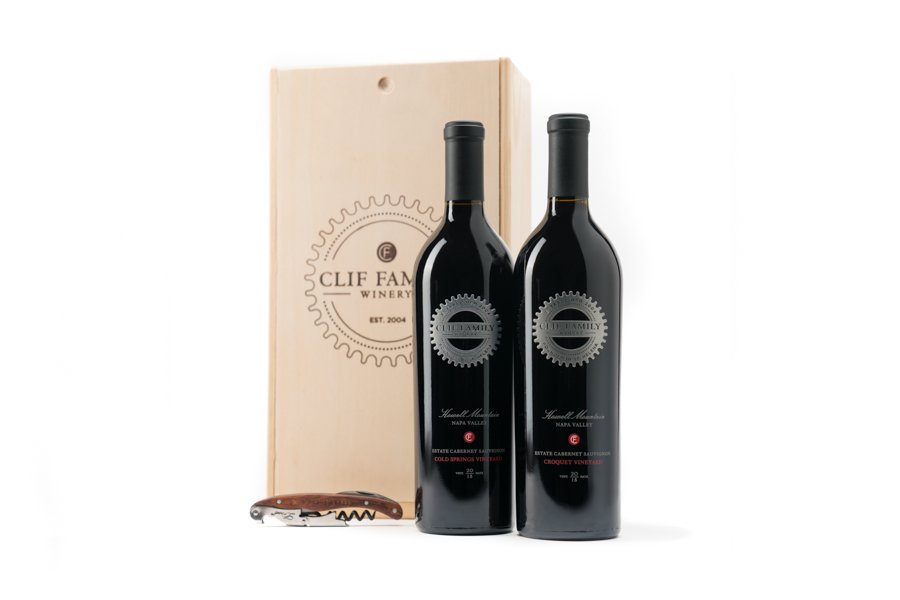 Two bottles of Clif Family Winery wine with a wooden gift box and a corkscrew.