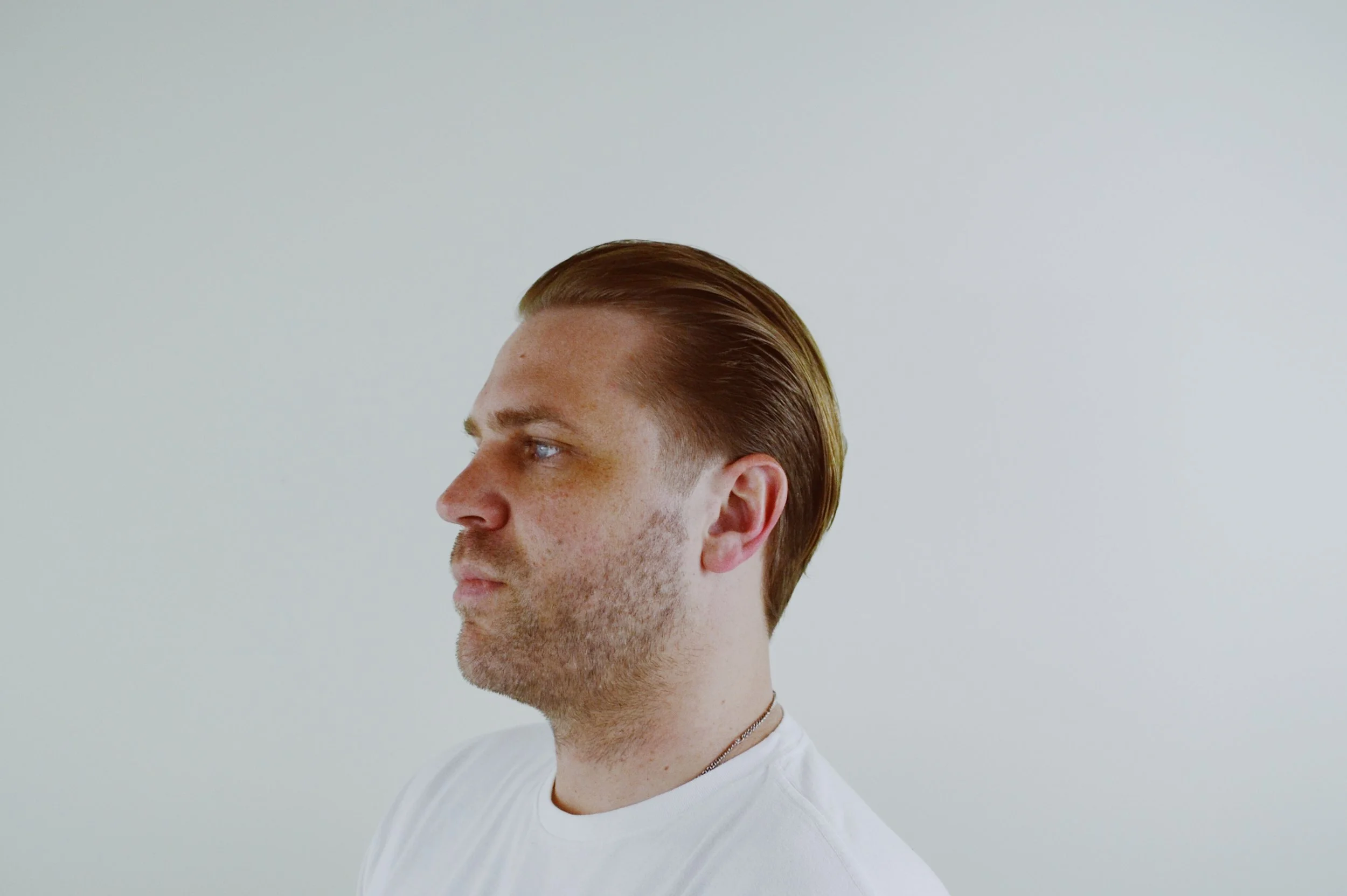 longer hairstyle with tapered sides to allow for longer visits between haircuts