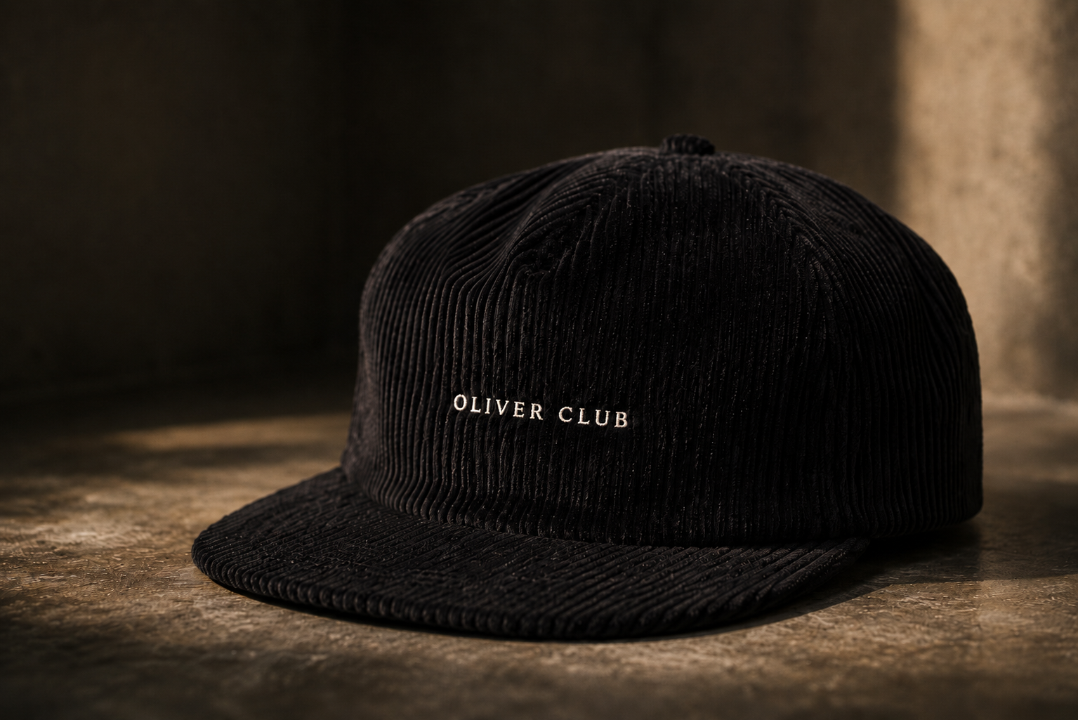 Black hat with Oliver Club text embroidered