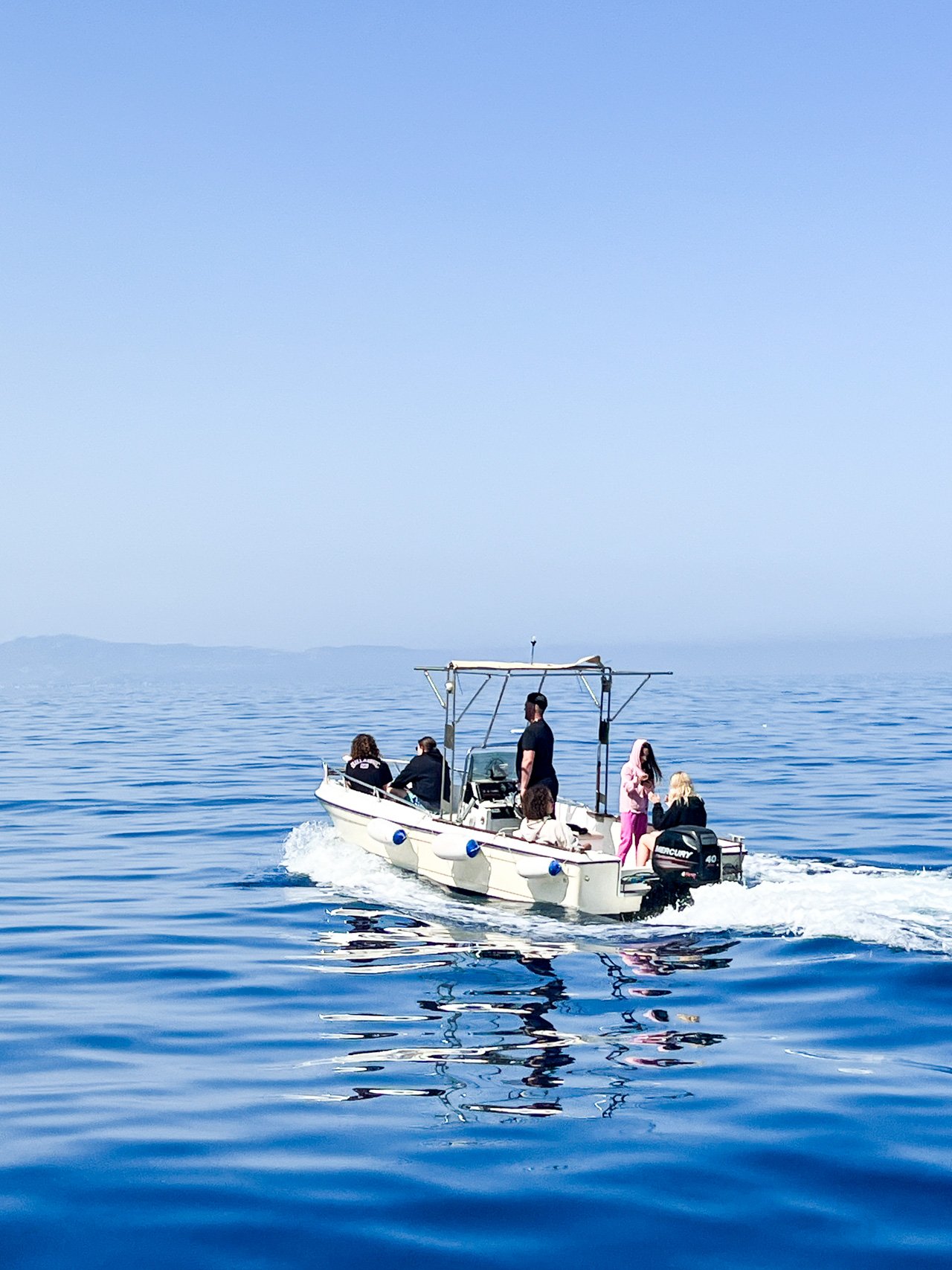 People on a power boat in Calabria.jpg