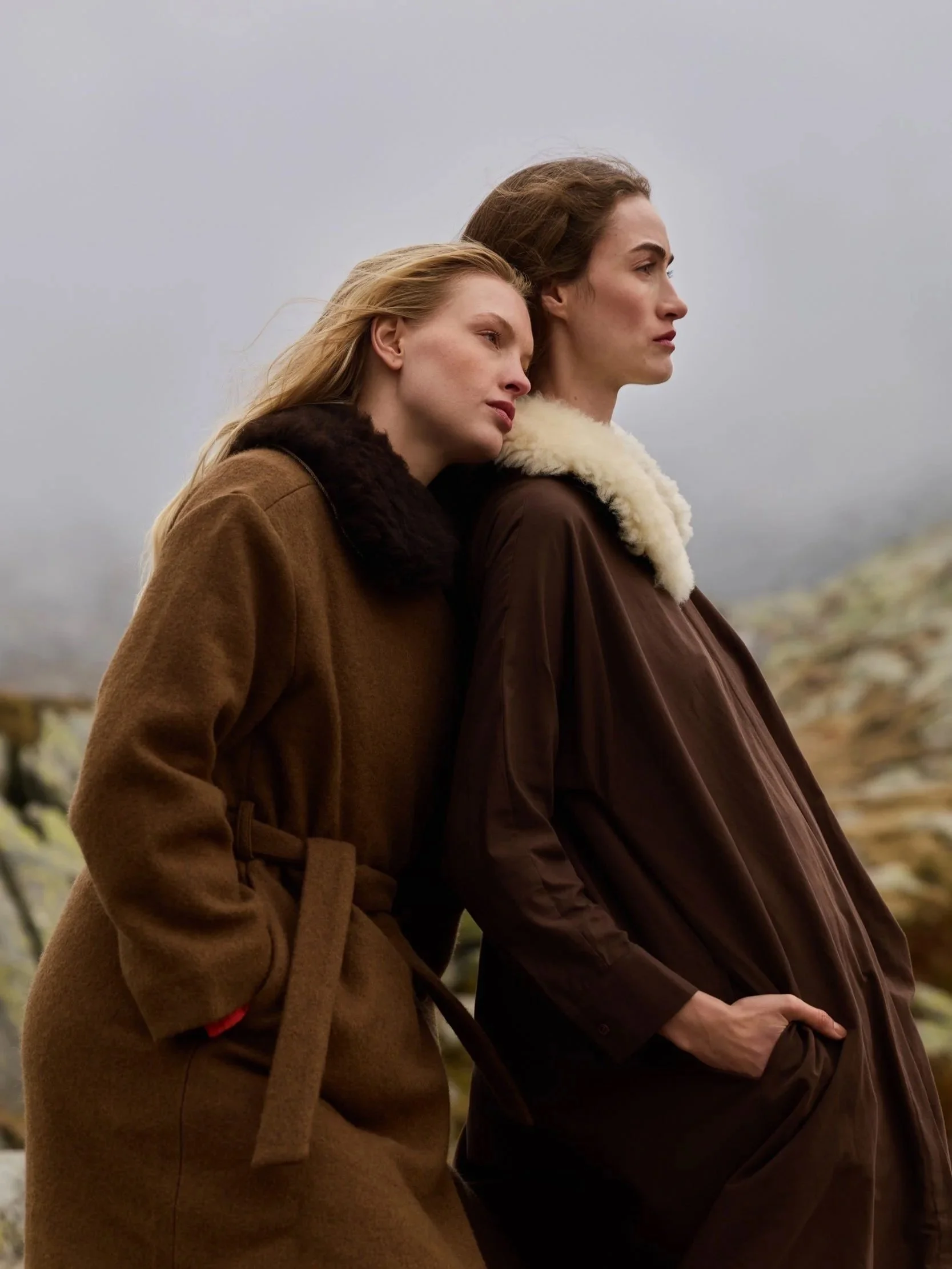 A brown-and-white sheepskin collar, worn with a wool coat and dress in the misty Swiss Alps