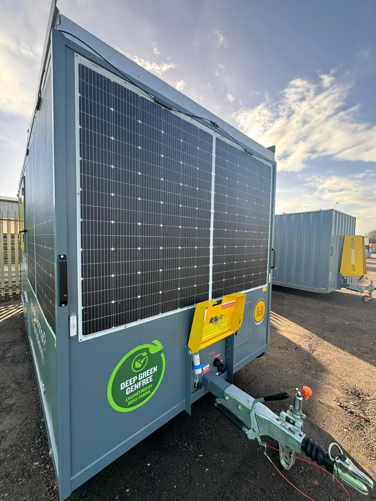 Solar power generator unit with solar panels, mounted on a trailer, labeled 'Deep Green', outdoors on a paved surface under cloudy sky.